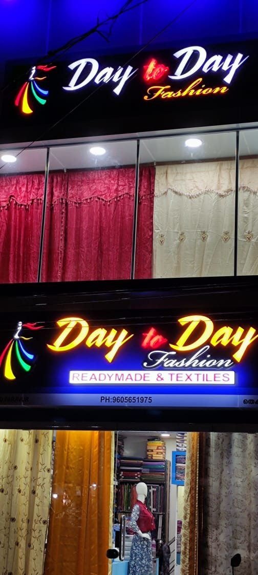 Day to Day Fashion showroom storefront lit up in the evening, Paravur